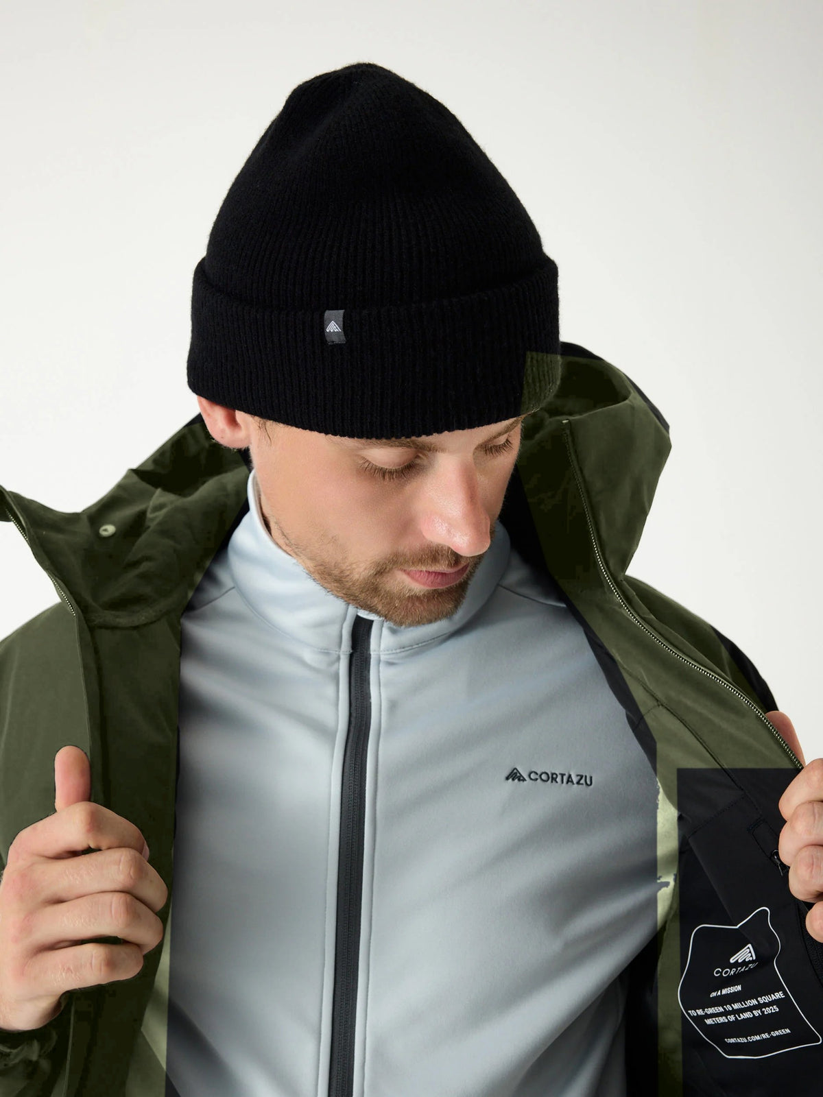 Cortazu Delta INS Shell Jacket men's in Mud Green, worn open over a mid layer