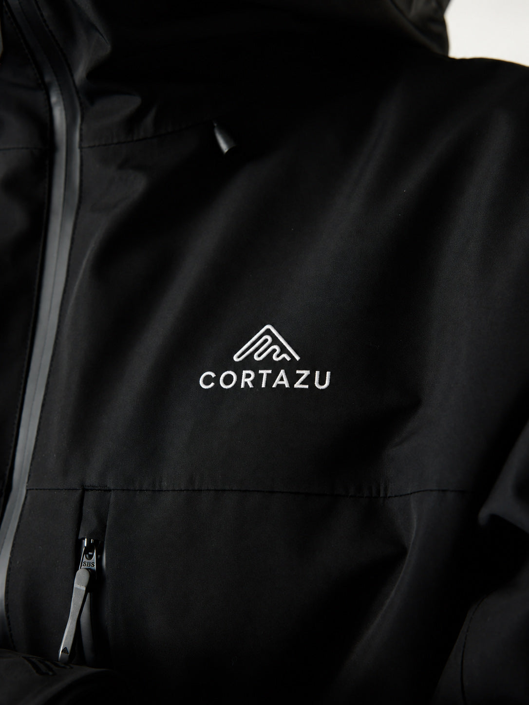 Cortazu Nunatak INS Ski Jacket men's in Black, logo detail on chest